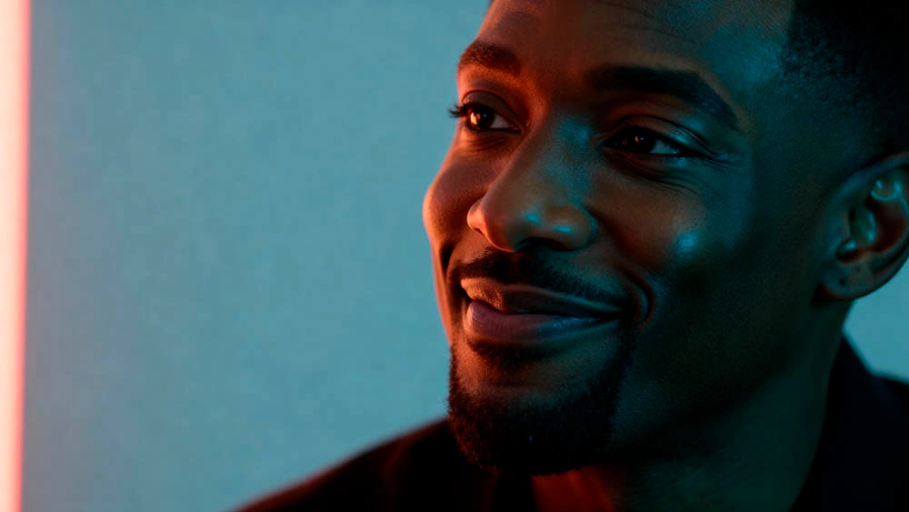 charismatic man listening focused neon cinematic atmosphere