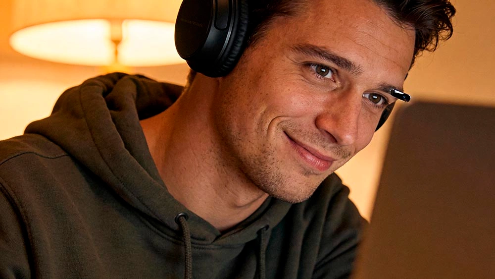 ask for a video call moment man looking toward webcam laptop screen not visible