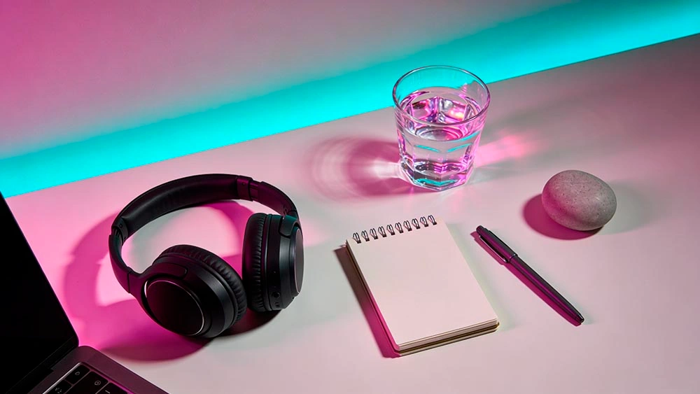 desk still life for video call anxiety with earbuds water glass and timer no screens