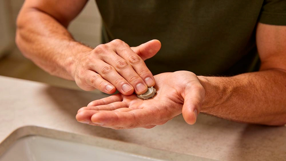 easy hair fixes for men on camera: applying a small amount of matte product
